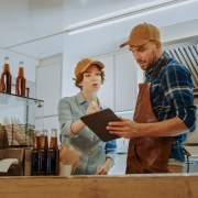 man and woman reviewing business data on tablet inside food truck